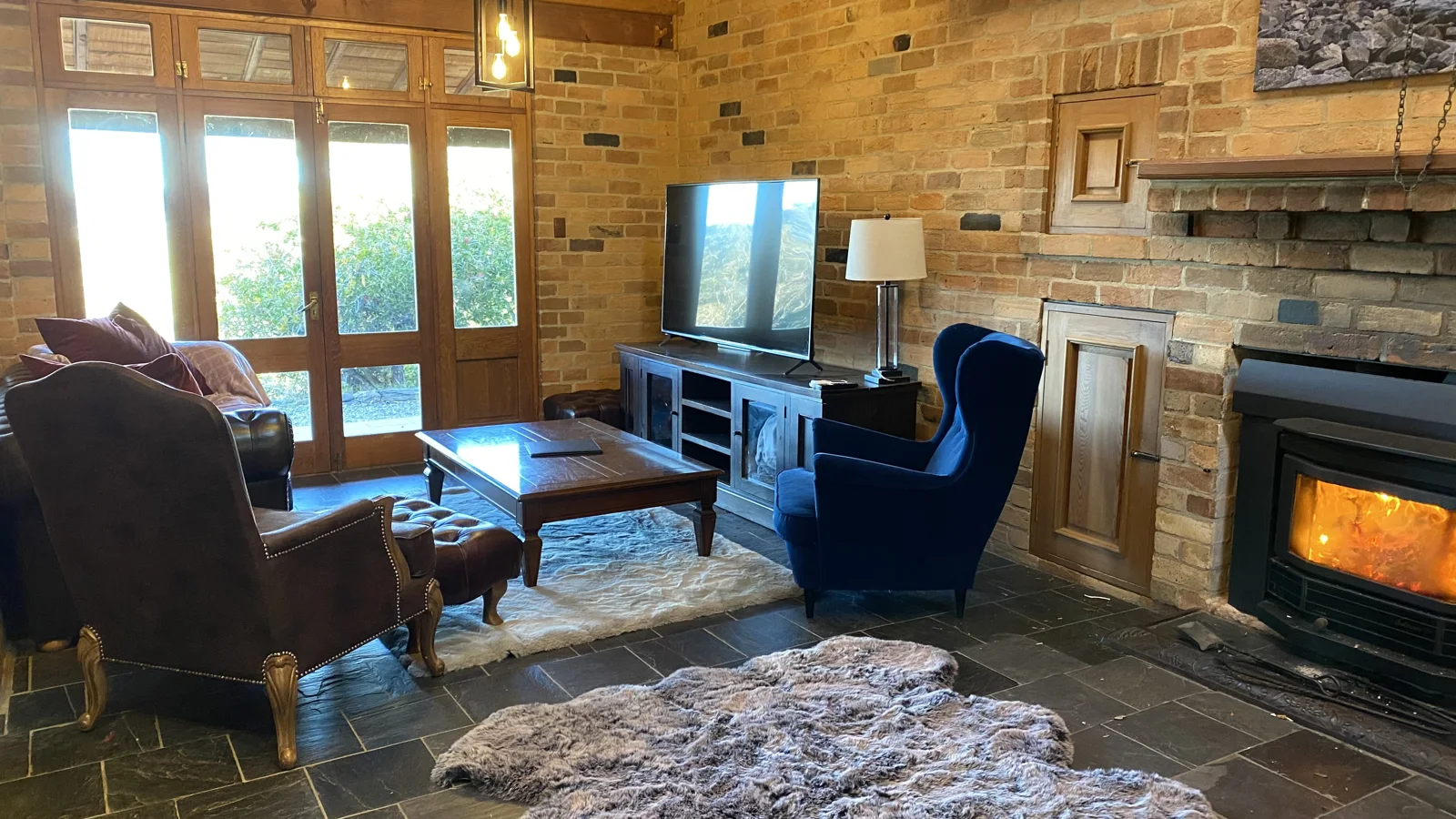 Armchairs beside the wood fireplace in the living room